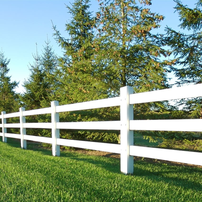White fence in a green field 