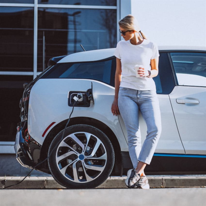 Woman in front of electric vehicle