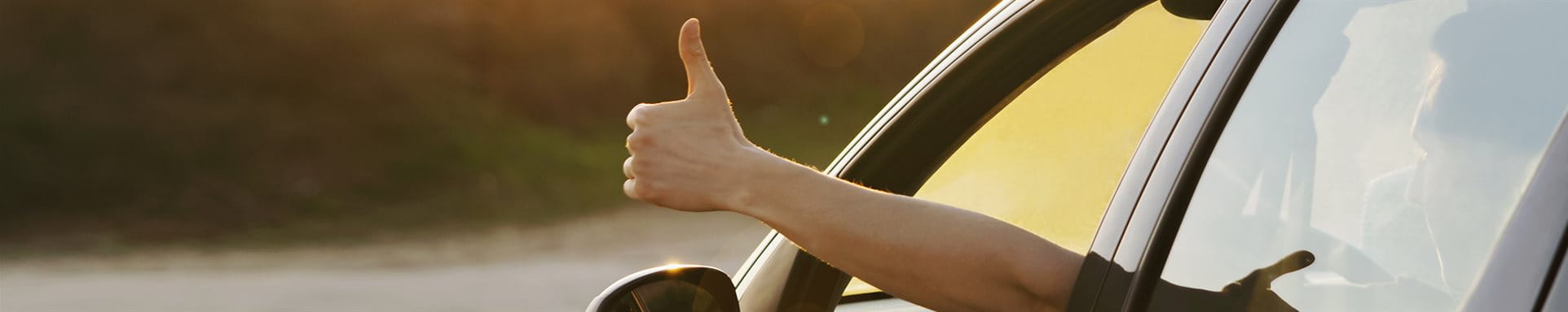 Thumb up from car window