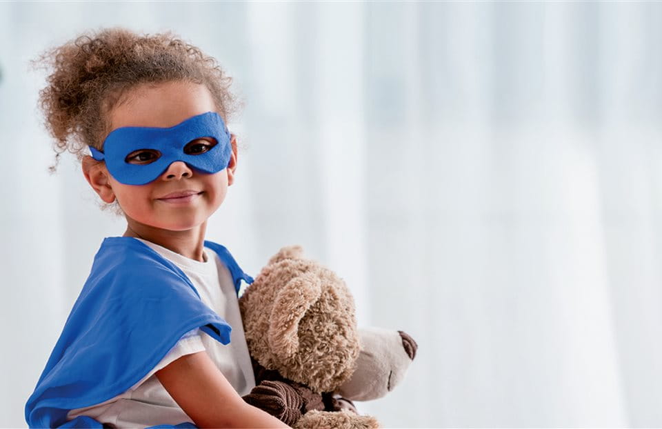 Child with mask and teddy