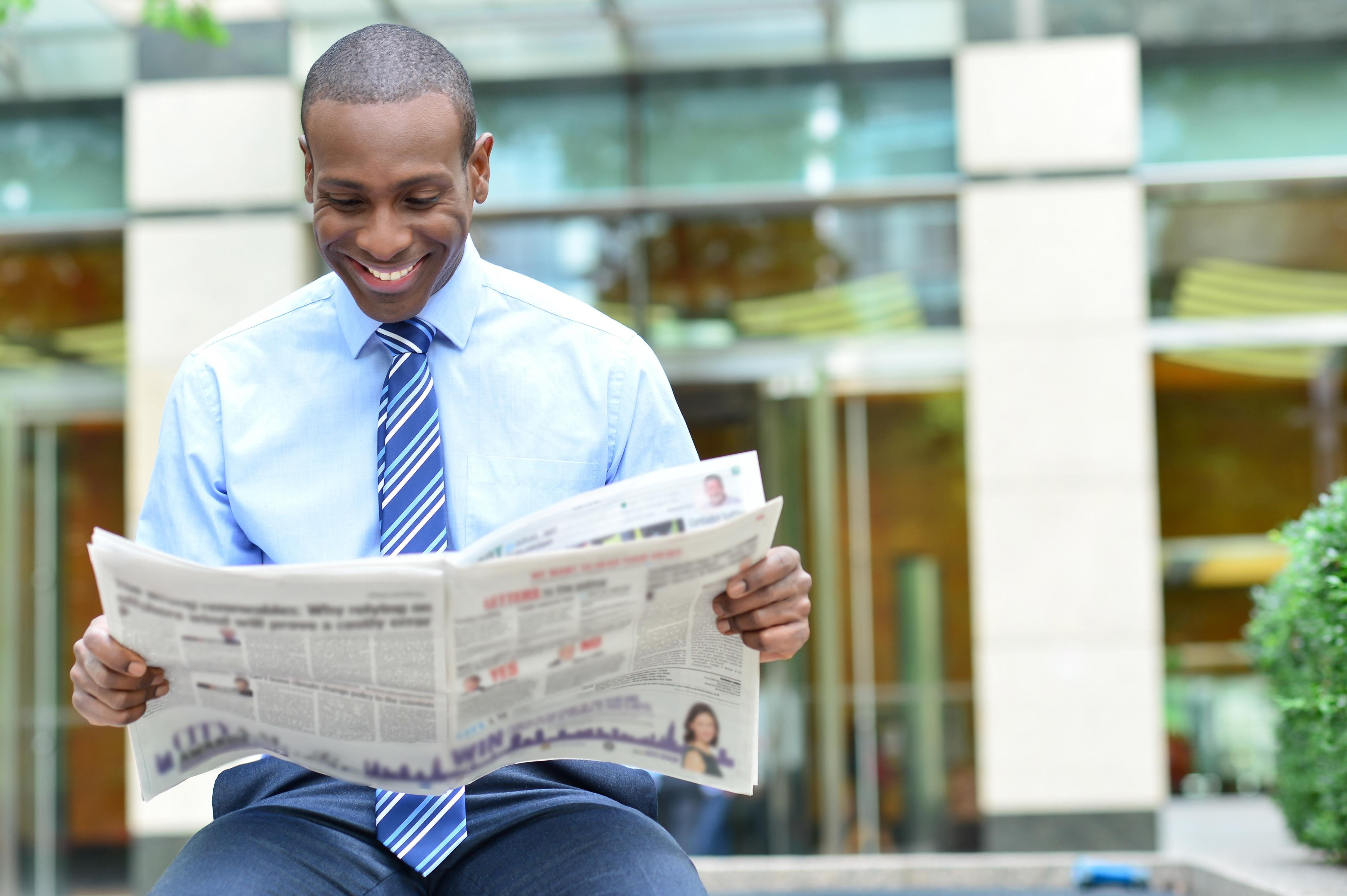 Man reads newspaper 